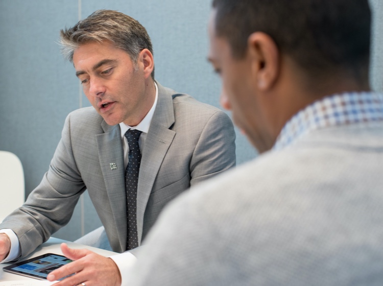 Man looking at tablet while speaking